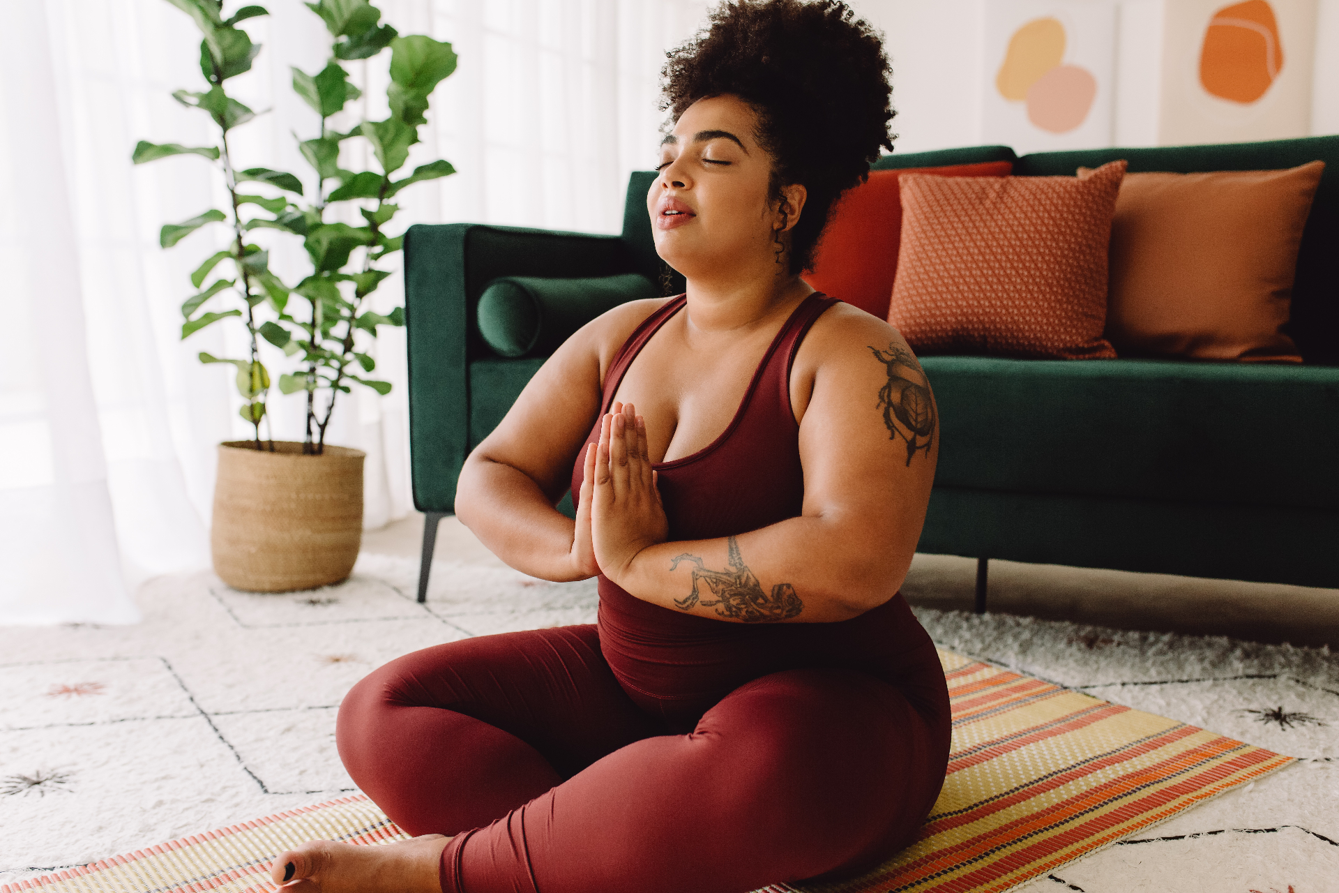 Woman meditating peacefully at home, embodying a calm relationship with her body and food